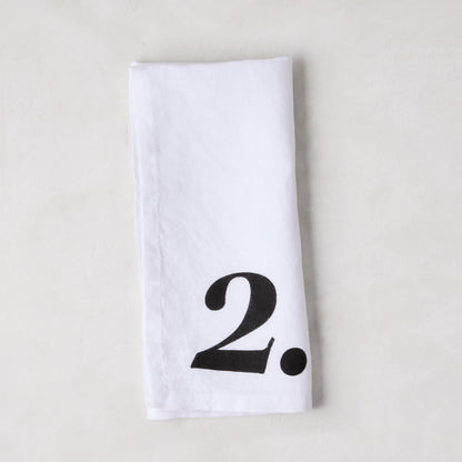 Diane Keaton + Hudson Grace white linen napkin with a bold black number 2.
