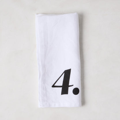 Diane Keaton + Hudson Grace white linen numeric napkin with a bold black number 4.