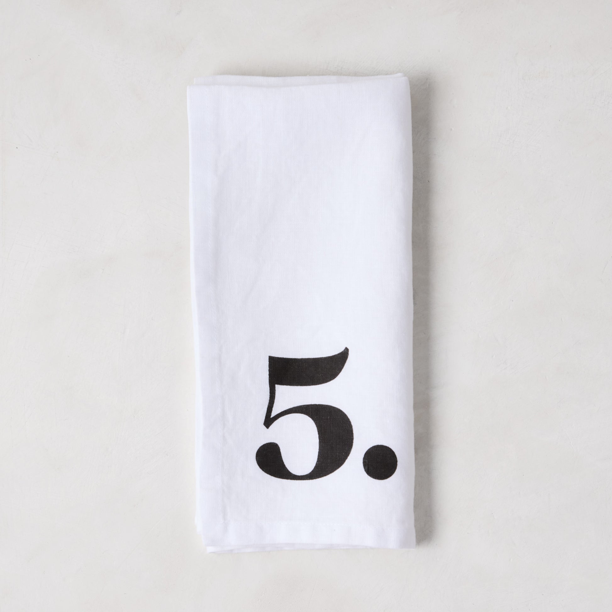Diane Keaton + Hudson Grace white linen napkin with a bold black number 5.