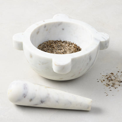Diane Keaton + Hudson Grace white marble mortar and pestle, with spices in the mortar.