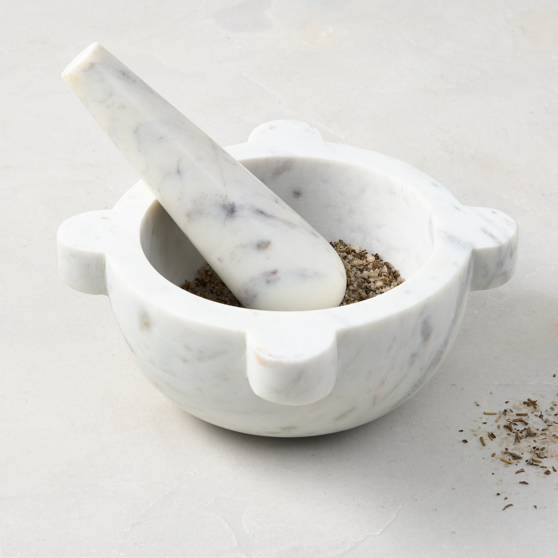 Diane Keaton + Hudson Grace white marble mortar and pestle with spices.