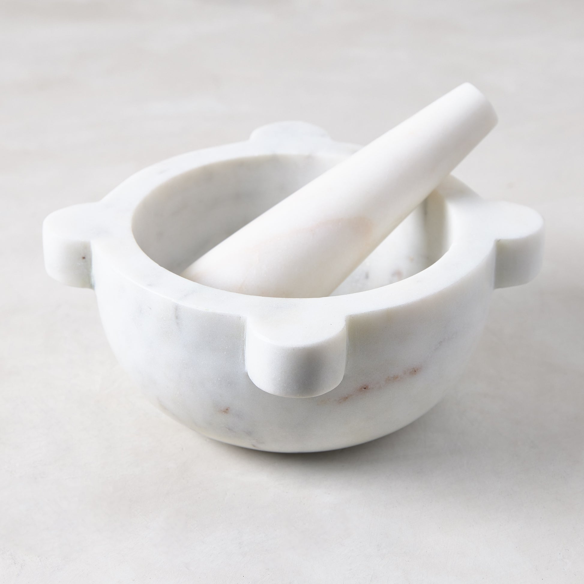 Diane Keaton + Hudson Grace white marble mortar and pestle with natural variations.