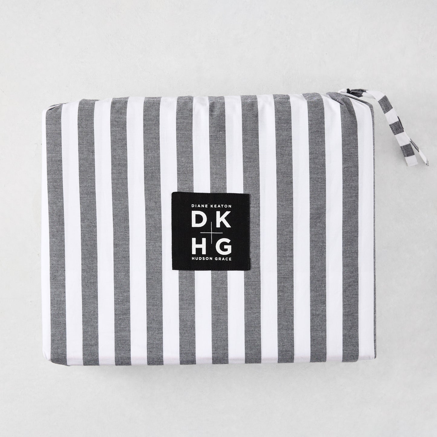 Diane Keaton + Hudson Grace Yarn Dyed Striped Percale Sheet Set, folded with black and white stripes.