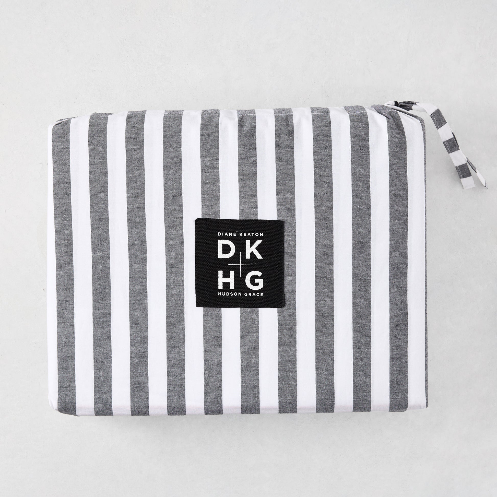 Diane Keaton + Hudson Grace Yarn Dyed Striped Percale Sheet Set, folded with black and white stripes.