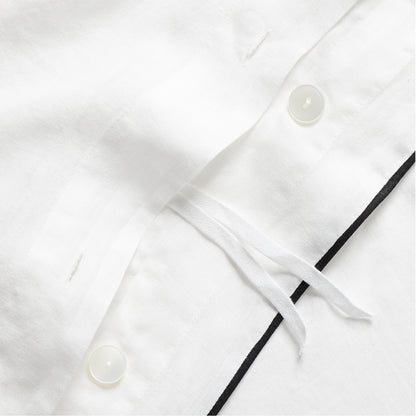 Diane Keaton + Hudson Washed Linen Duvet Cover, white with black piping, button closure, and ties.