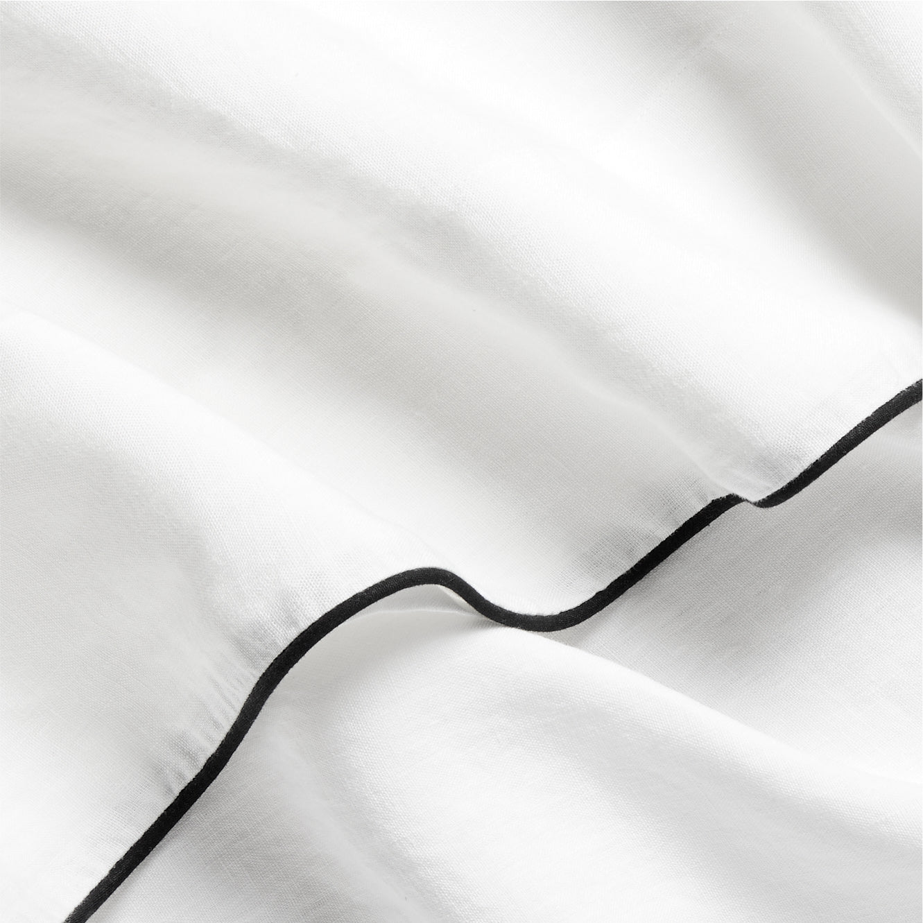 Diane Keaton + Hudson white washed linen duvet cover with black piping.