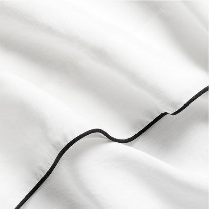 Diane Keaton + Hudson white washed linen duvet cover with black piping.