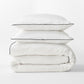 Diane Keaton + Hudson Washed Linen Duvet Cover and shams with black piping, stacked.