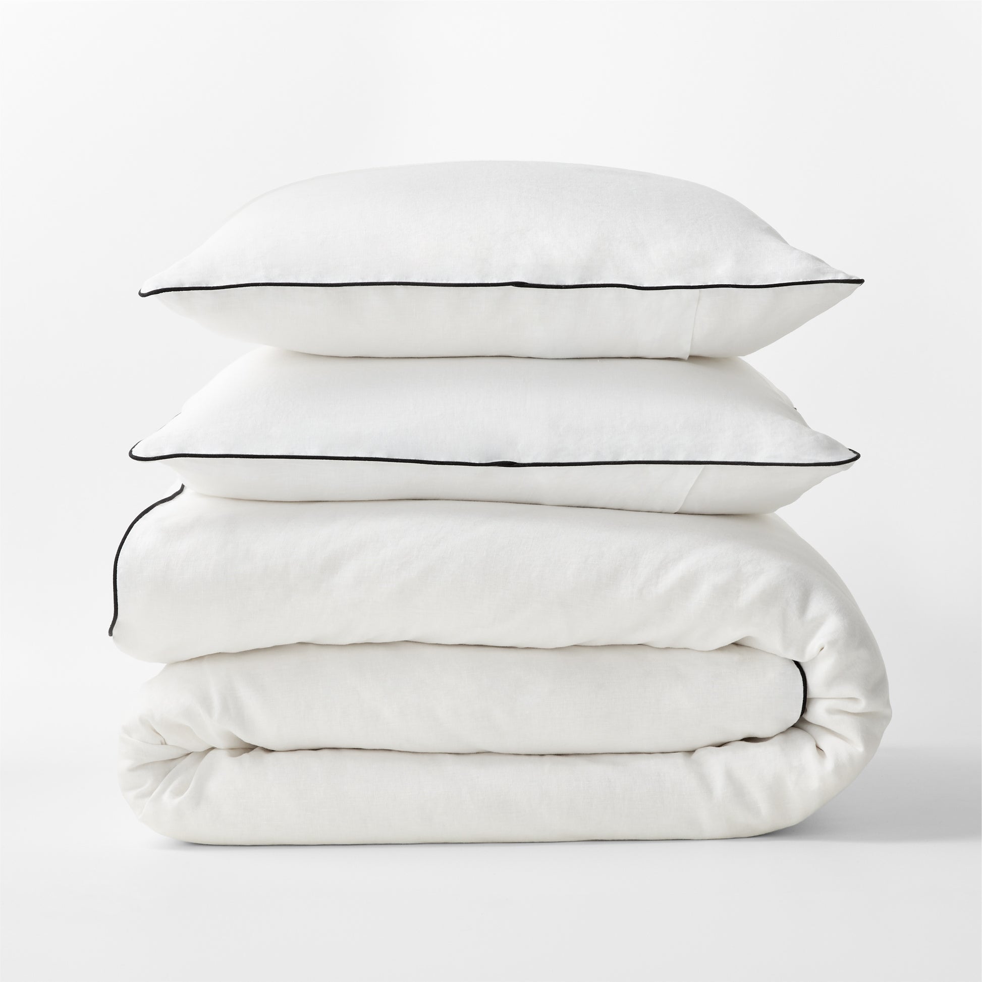 Diane Keaton + Hudson Washed Linen Duvet Cover and shams with black piping, stacked.