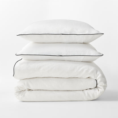 Diane Keaton + Hudson Washed Linen Duvet Cover and shams with black piping, stacked.