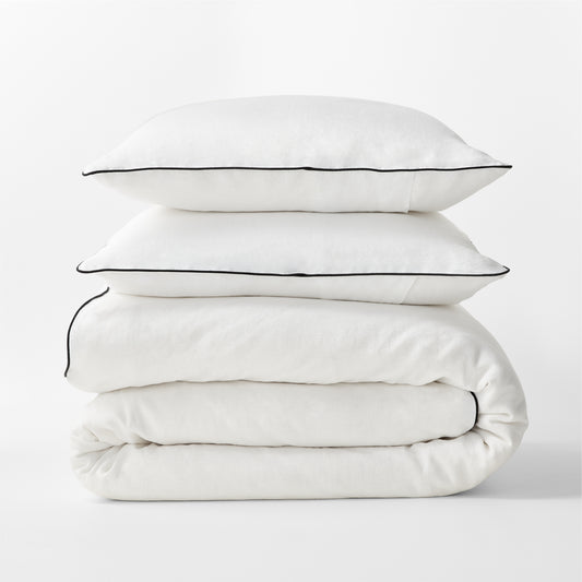 Diane Keaton + Hudson Washed Linen Duvet Cover and shams with black piping, stacked.