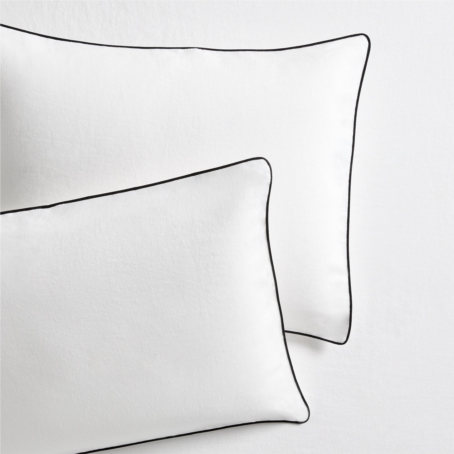 Set of 2 white washed linen shams with black piping, from the Diane Keaton x Hudson Grace Collection.