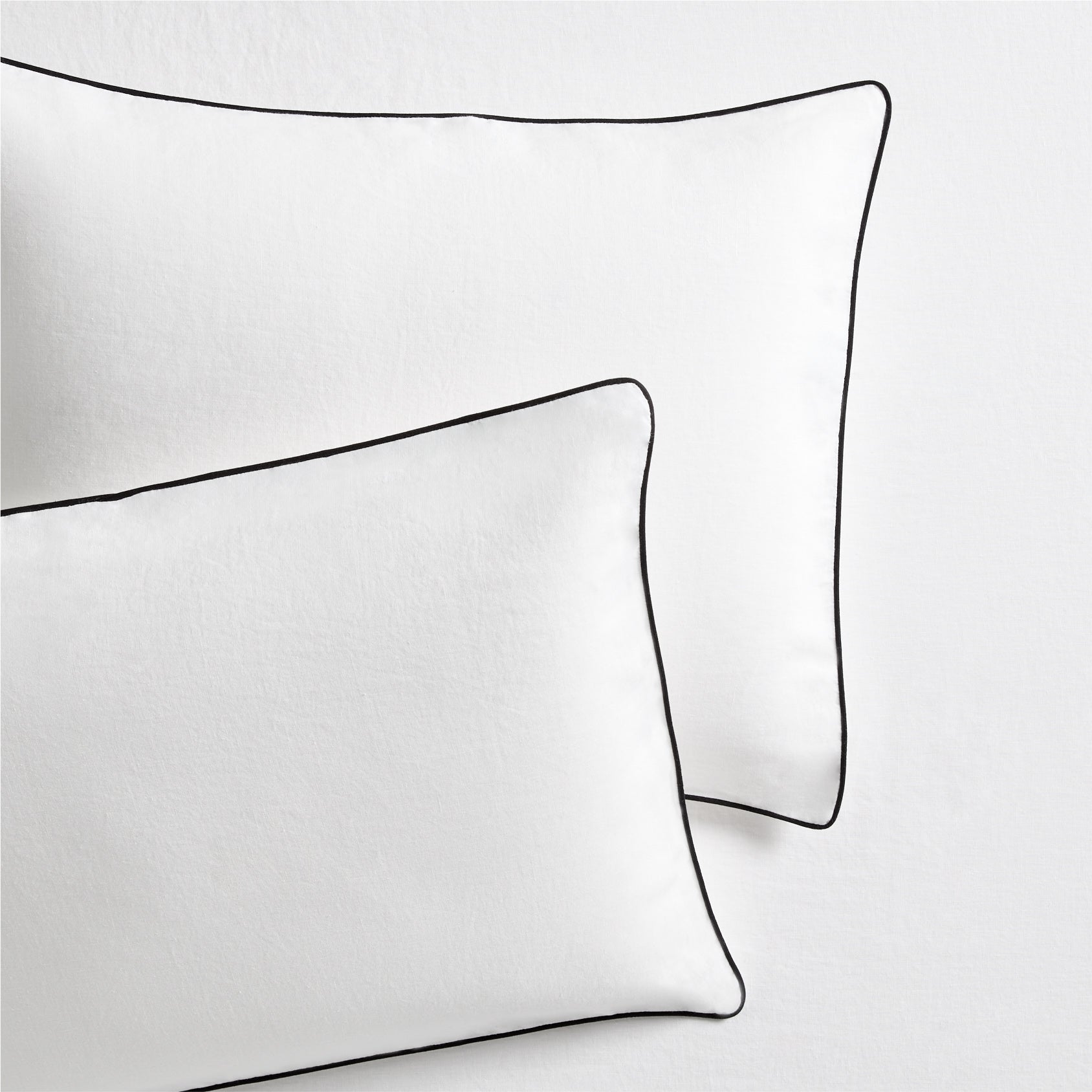 Set of 2 white washed linen shams with black piping, from the Diane Keaton x Hudson Grace Collection.
