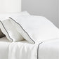 Diane Keaton + Hudson white washed linen sheet set with black piping on pillows and flat sheet.
