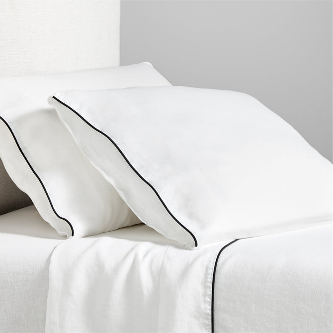 Diane Keaton + Hudson white washed linen sheet set with black piping on pillows and flat sheet.