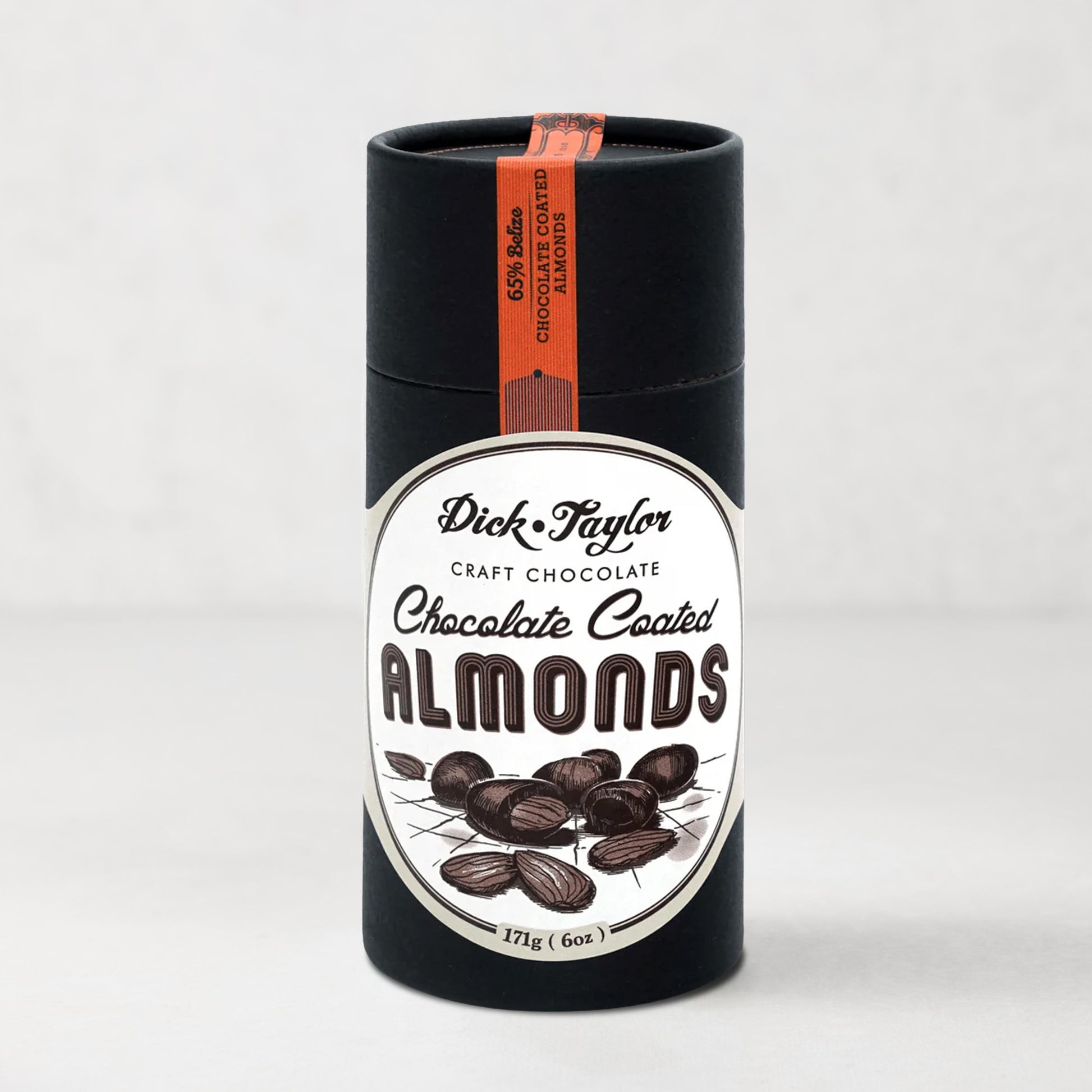 Dick Taylor Chocolate Coated Almonds in a tall, black cylindrical container with a white and black label.