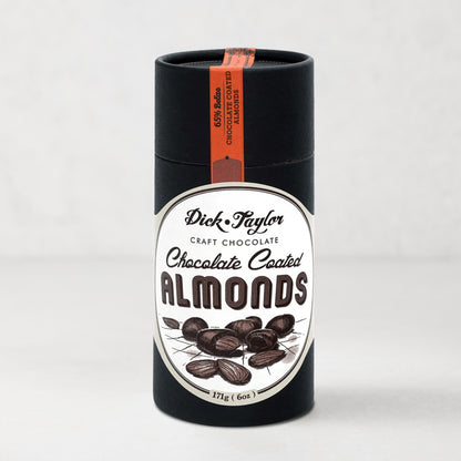 Dick Taylor Chocolate Coated Almonds in a tall, black cylindrical container with a white and black label.