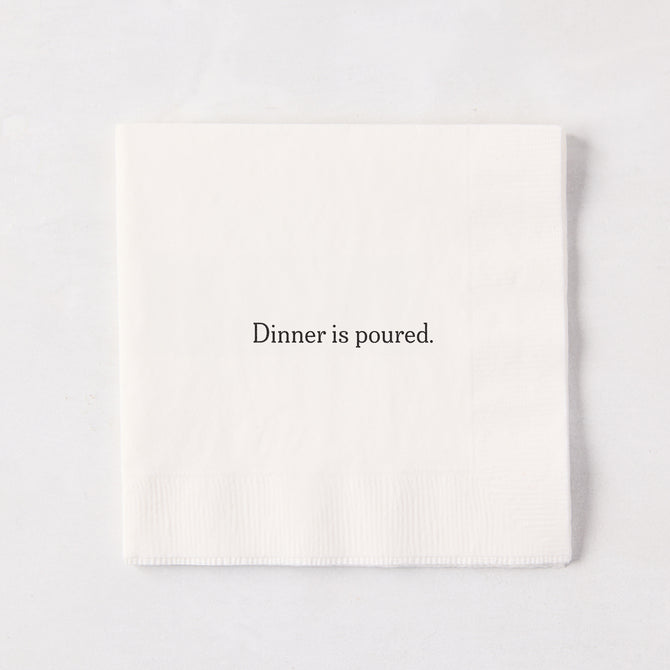 White 5.5" square paper cocktail napkin with "Dinner is poured." in black text.
