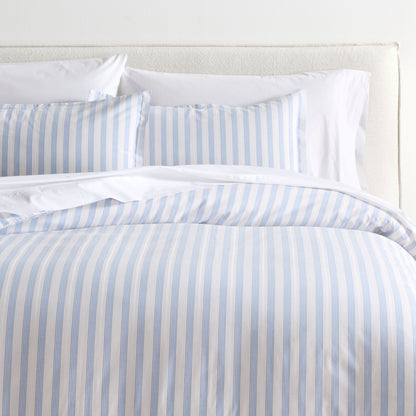 Dobby Blue Stripe Cotton Duvet Set with light blue and white vertical stripes on a bed.