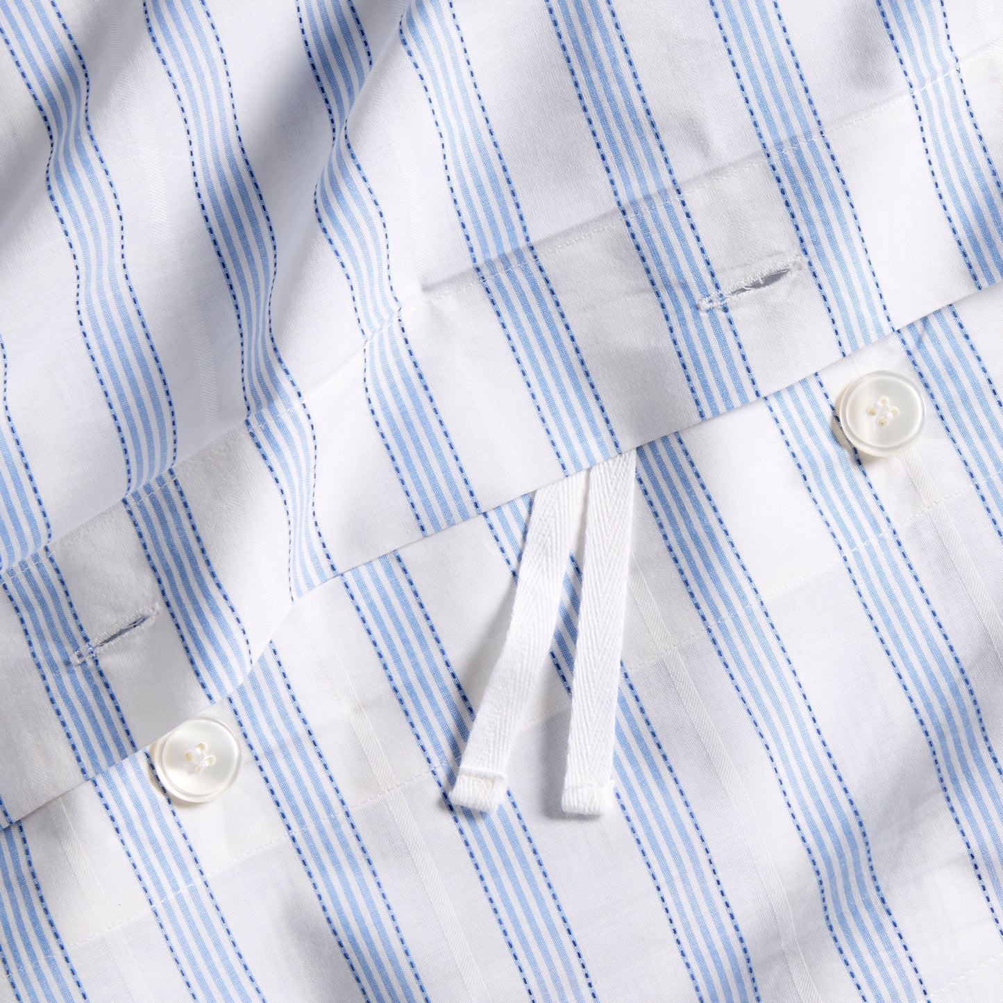 Dobby Blue Stripe Cotton Duvet Set with white buttons and ties, subtle geometric texture.