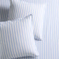 Two Dobby Blue Stripe Cotton Euro Shams with subtle texture, on a matching striped sheet.