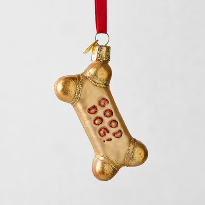 Gold glitter glass dog bone Christmas ornament with "GOOD DOG!" in red.