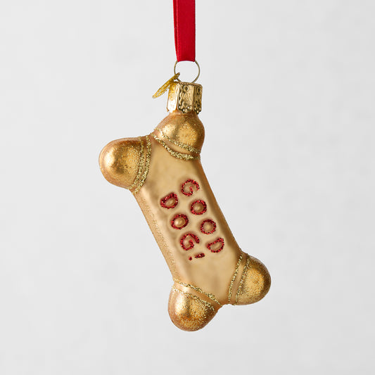 Gold glitter glass dog bone Christmas ornament with "GOOD DOG!" in red.