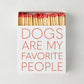 White oversized matchbox with "Dogs Are My Favorite People" in red text, filled with long red-tipped matches.