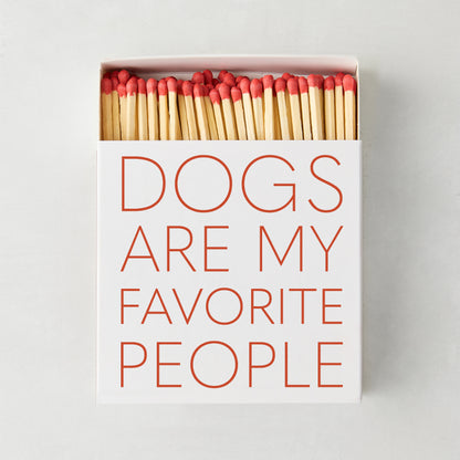 White oversized matchbox with "Dogs Are My Favorite People" in red text, filled with long red-tipped matches.