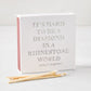 Square white matchbox with holographic text reading It's Hard to be a Diamond in a Rhinestone World by Dolly Parton.