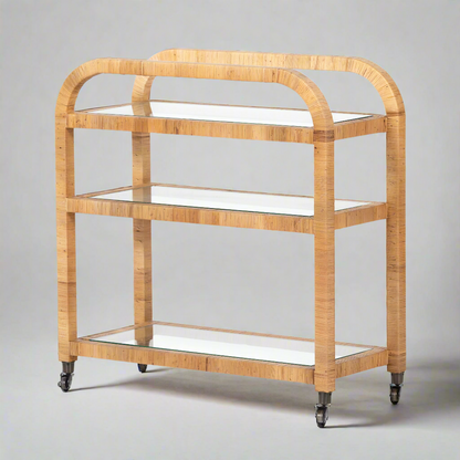 Dory Rattan Bar Cart: Honey-finished rattan bar cart with three glass tiers and wheels.