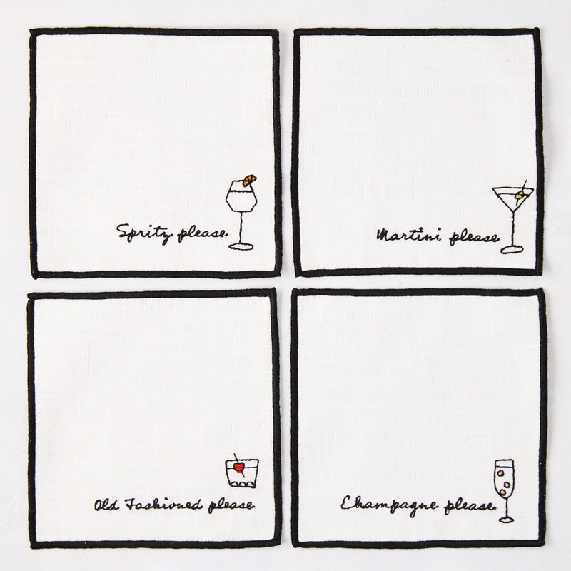 Set of 4 white cotton coasters with black embroidered cocktail designs: Spritz, Martini, Old Fashioned, Champagne.