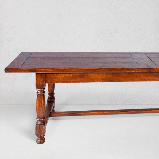Du Mas extendable oak dining table with rich brown finish and turned legs.