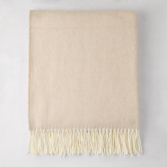 Dune Italian Herringbone Throw Blanket, cashmere-soft cotton-acrylic, with decorative fringe.