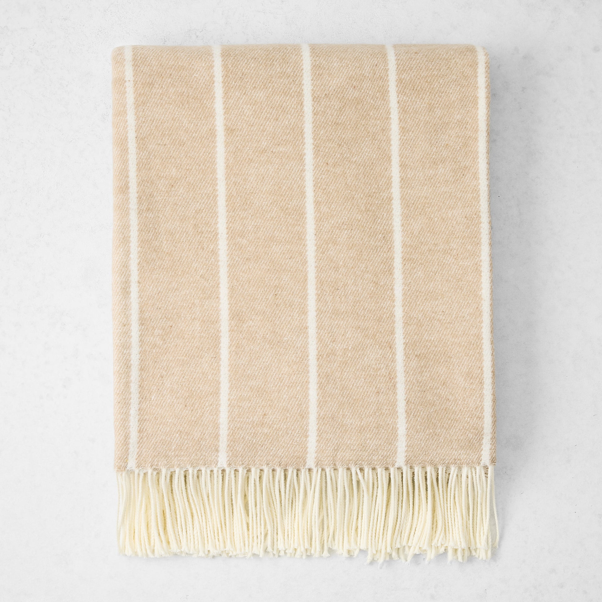 Dune Fiji Stripe Throw Blanket, light beige with vertical cream stripes and fringe, 50% Cotton, 50% Acrylic.