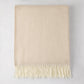 Dune Italian Herringbone Throw Blanket, cashmere-soft cotton-acrylic, with decorative fringe.