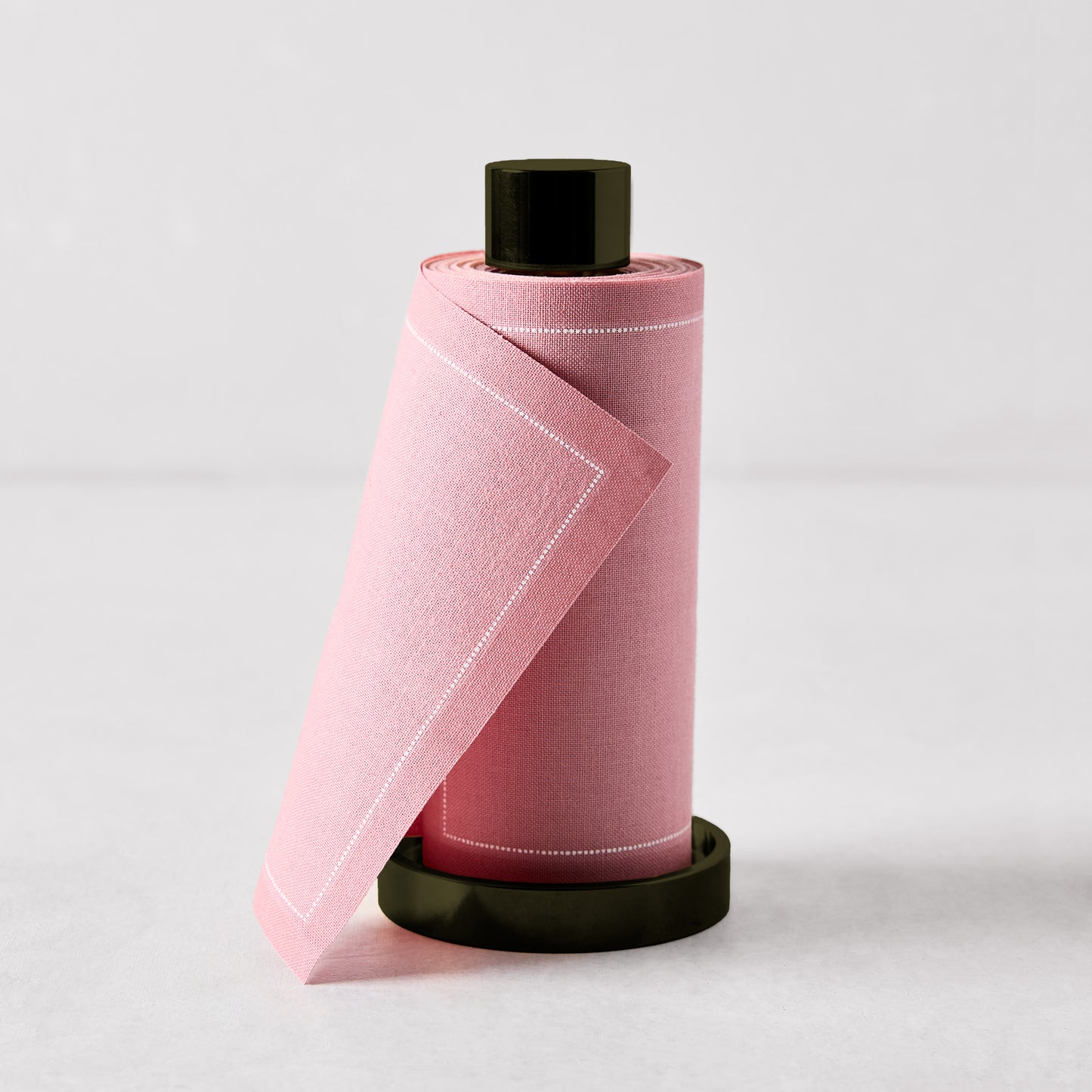 Dusty pink tear-off cotton napkins on a black metal holder, 5"H.