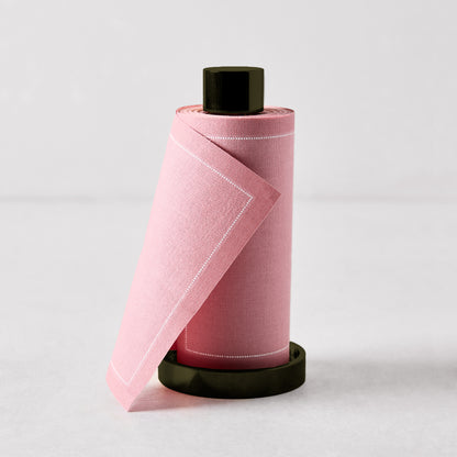 Dusty pink tear-off cotton napkins on a black metal holder, 5"H.