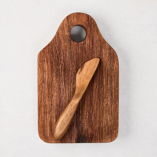 Dutch acacia wood cheese board with natural grain, small hole, and matching wooden spreader.