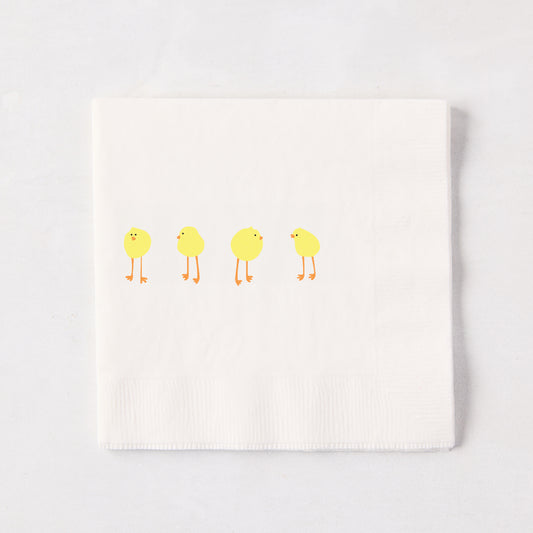 White 3-ply paper cocktail napkin with four yellow Easter chicks, 5.5" square.