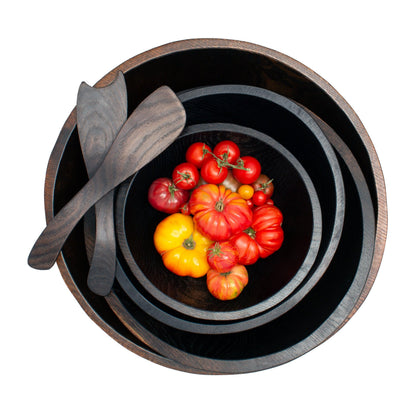 Ebonized rustic spalted maple wood salad servers and nesting bowls with colorful heirloom tomatoes.