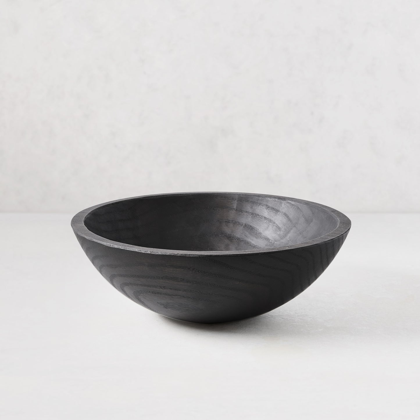 13" ebonized spalted wood bowl with dark, rich finish highlighting natural grain.
