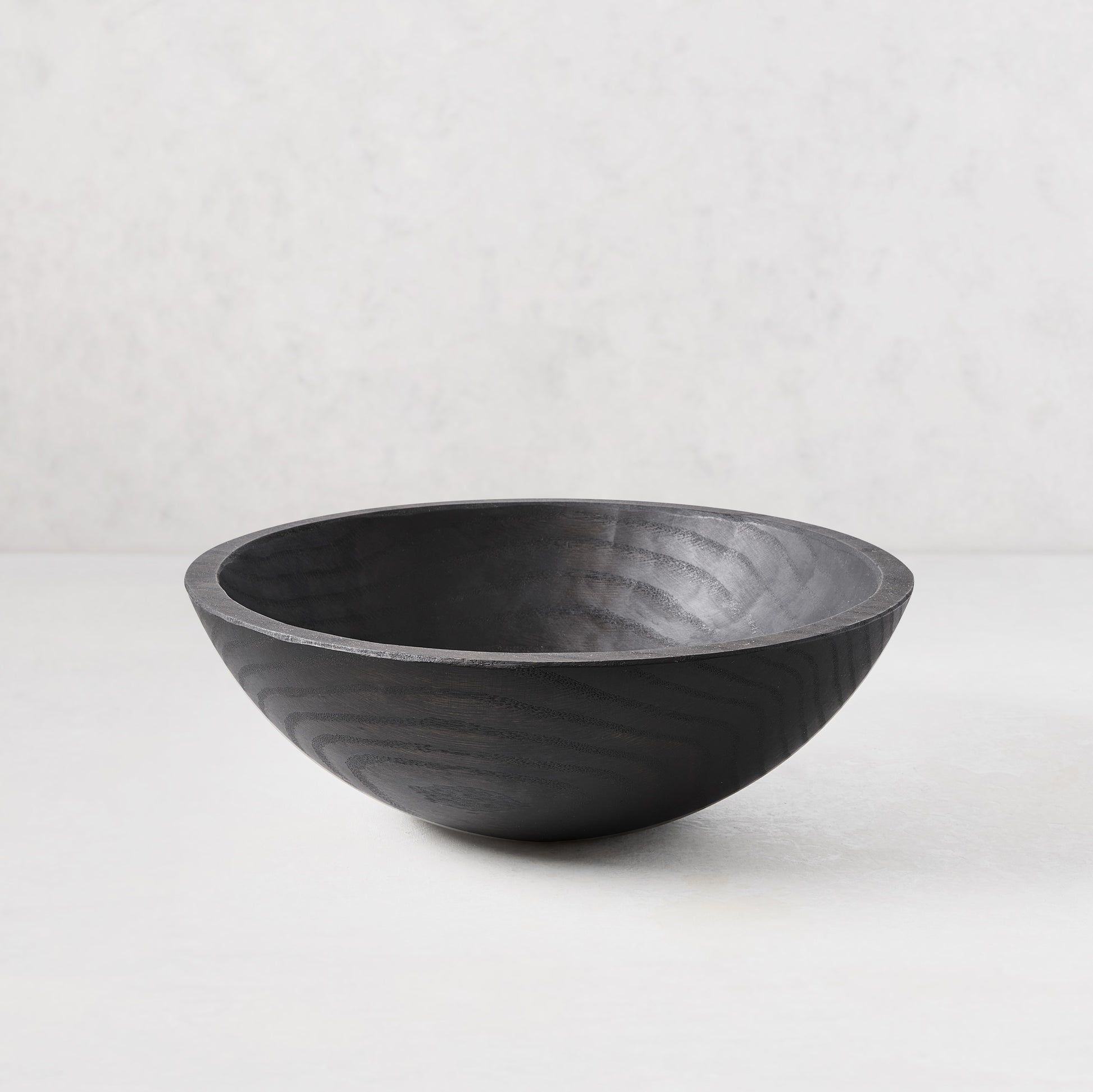 13" ebonized spalted wood bowl with dark, rich finish highlighting natural grain.