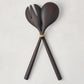Ebony teak wood long-handled 2-piece serving set, spoon and fork tied with twine, on a white background.