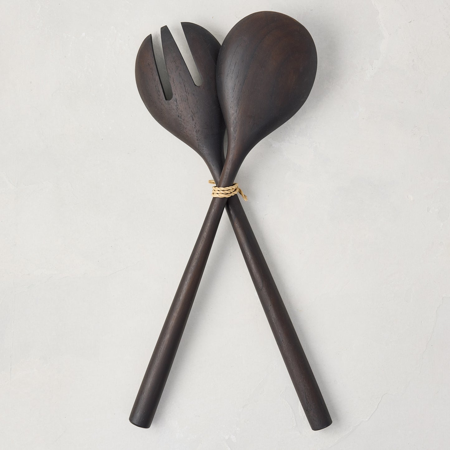 Ebony teak wood long-handled 2-piece serving set, spoon and fork tied with twine, on a white background.