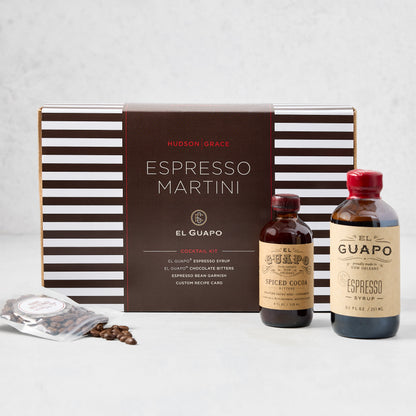 El Guapo Espresso Martini Cocktail Kit with striped box, espresso syrup, spiced cocoa, and coffee beans.