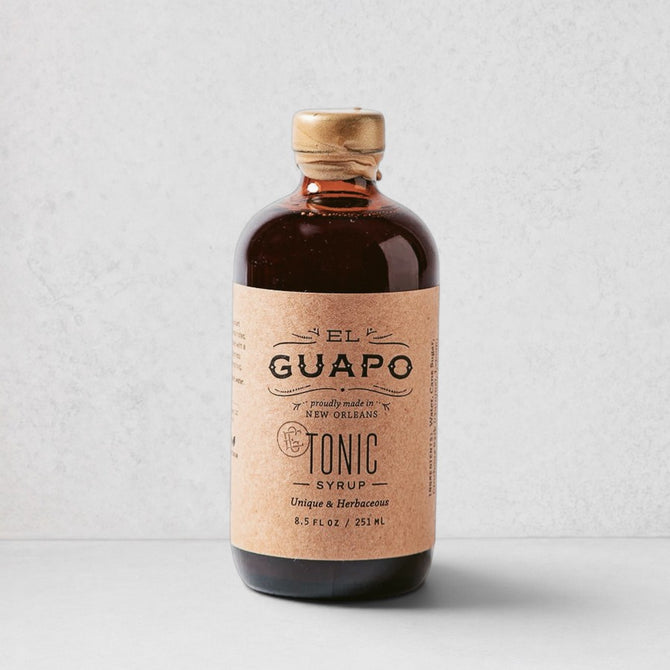 El Guapo Tonic Syrup in an 8.5 fl oz amber glass bottle with a kraft paper label and gold cap.