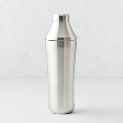 25oz brushed stainless steel cocktail shaker with integrated measuring cap and vacuum-insulated double-wall design.