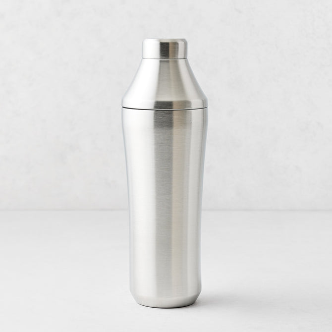 25oz brushed stainless steel cocktail shaker with integrated measuring cap and vacuum-insulated double-wall design.