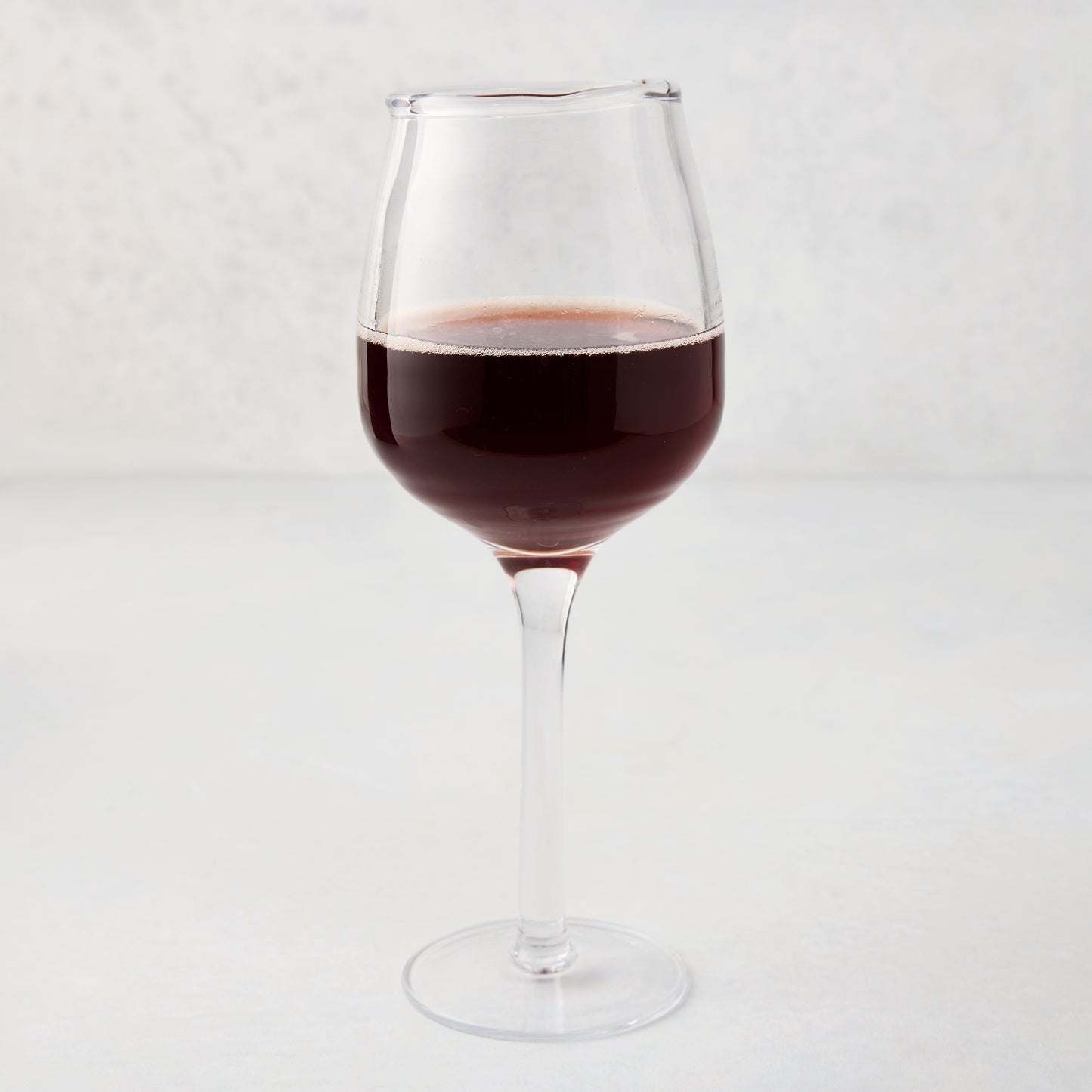 Elijah Large Scissor-Cut Wine Glass, 14 oz, clear thick air-blown glass with red wine.